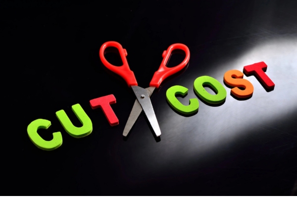 cut cost spelled using magnetic letters with a pair of scissors in the middle depicting propane use