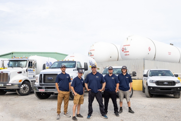 deBoer Team standing in front of propane trucks and tanks