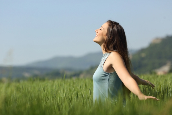 happy woman breathing fresh air outdoors