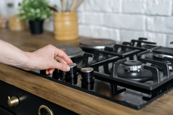 homeowner turning on the stove depicting wide range of propane use