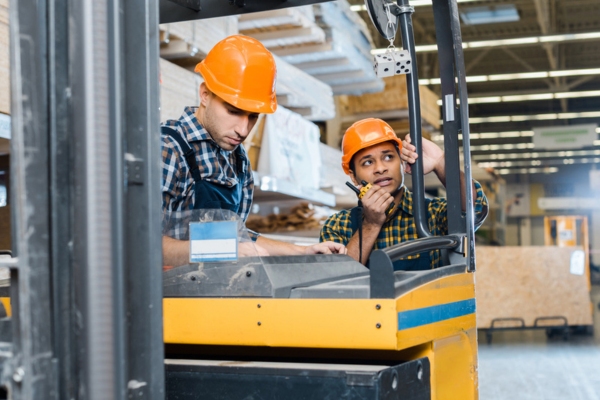 workers in a forklift