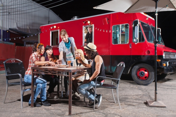 group of friends enjoying food by the food truck