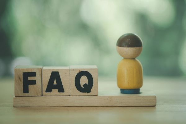 FAQ spelled using wooden letter cubes with a wood carved man depicting Propane Fleet Costs questions