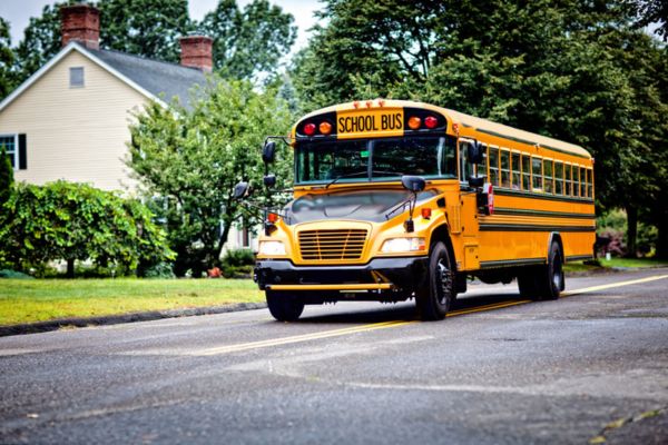 school bus driving in a residential area